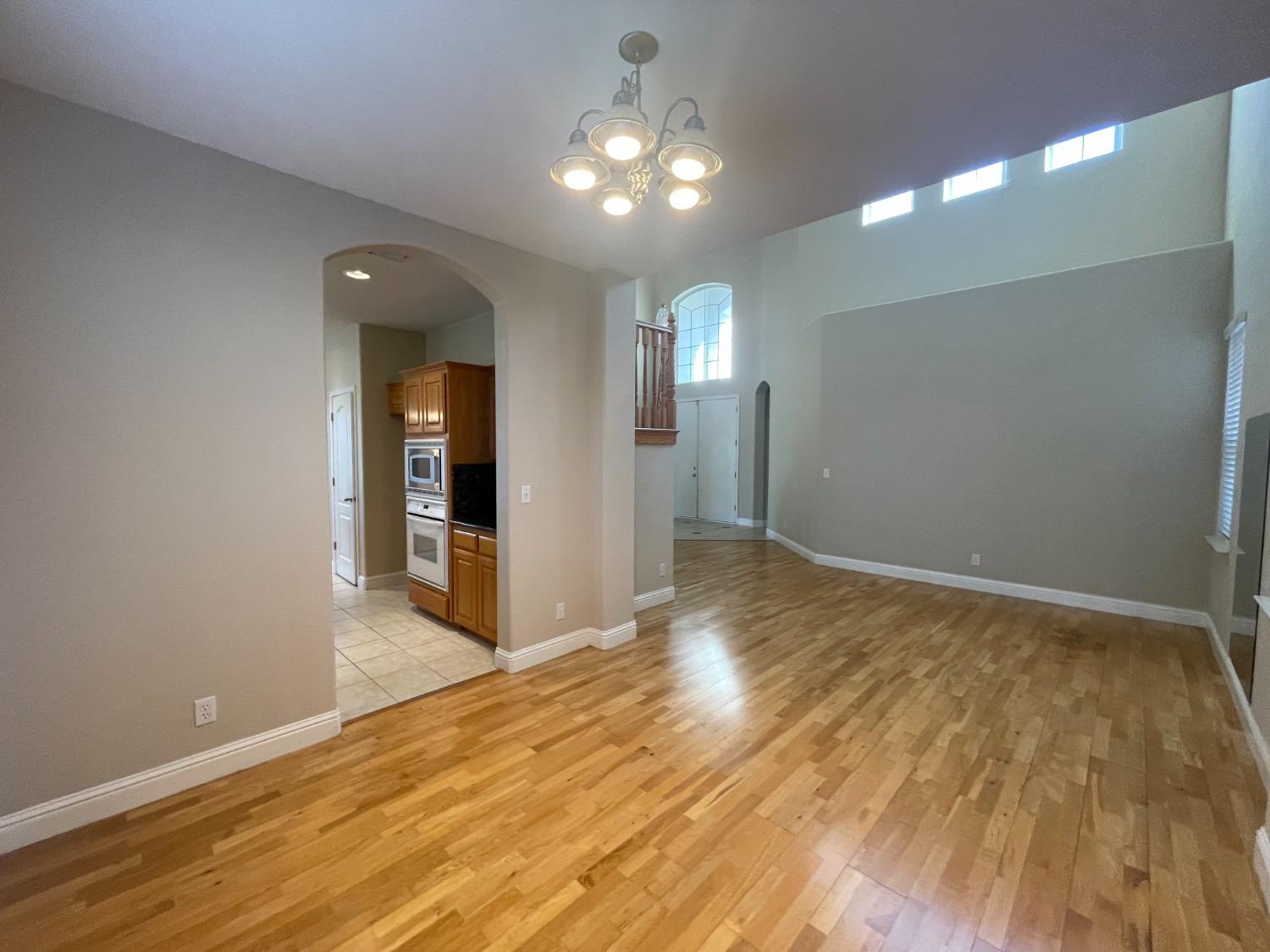 2616 Goshen Avenue Clovis, CA 93611 - Photo 12 of 39 wooden floor in an empty room with a mirror