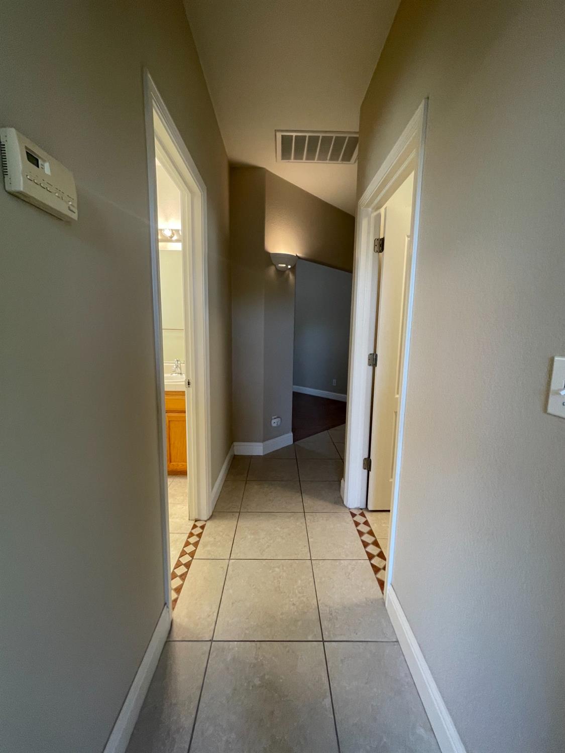 2616 Goshen Avenue Clovis, CA 93611 - Photo 13 of 39 a view of a hallway with wooden shelves