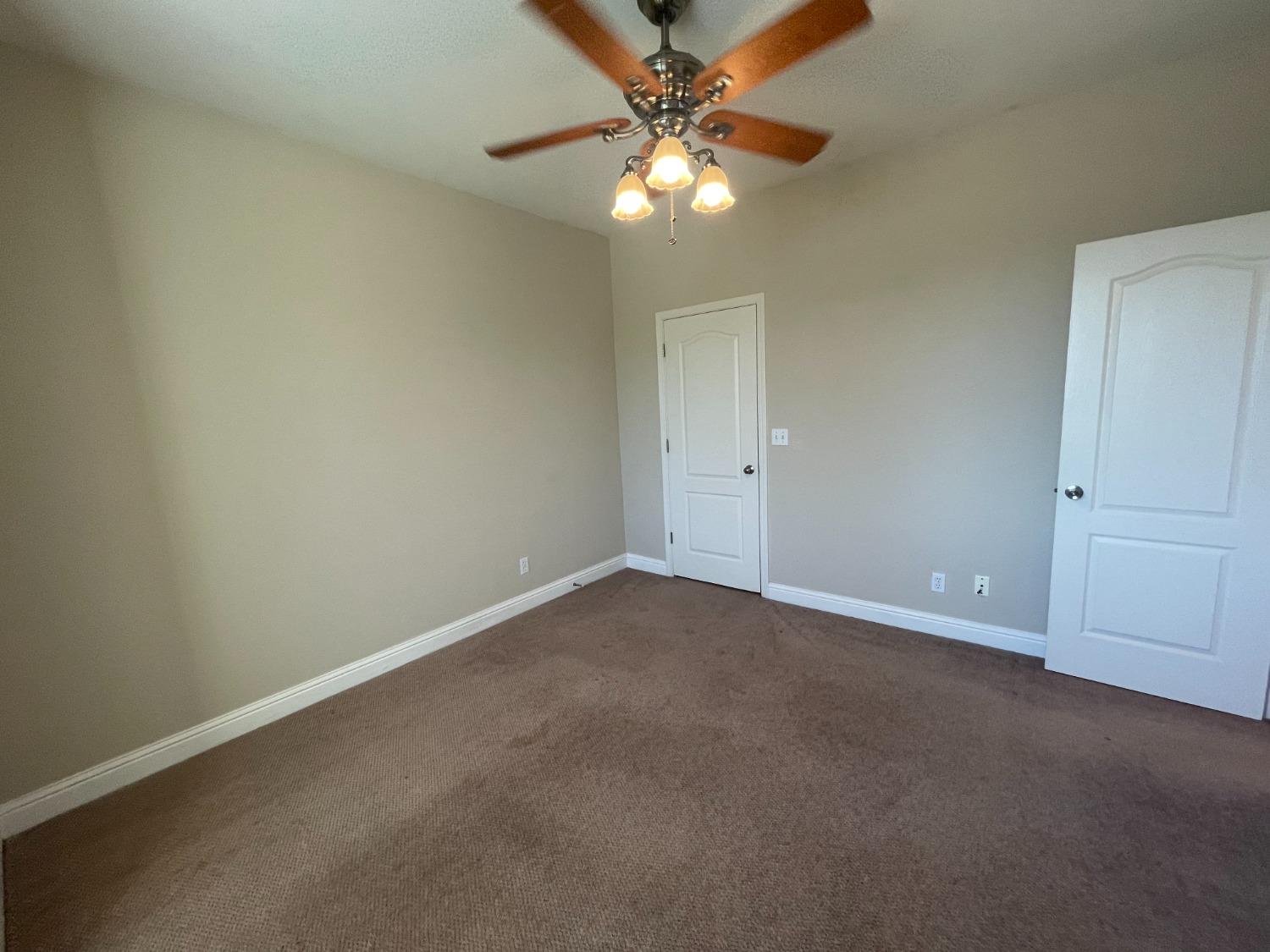 2616 Goshen Avenue Clovis, CA 93611 - Photo 26 of 39 a view of an empty room with a chandelier fan