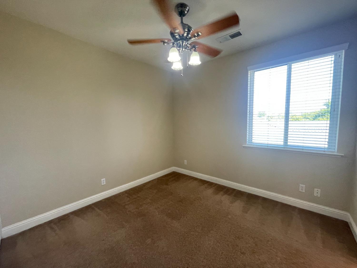 2616 Goshen Avenue Clovis, CA 93611 - Photo 30 of 39 an empty room with a window and a fan