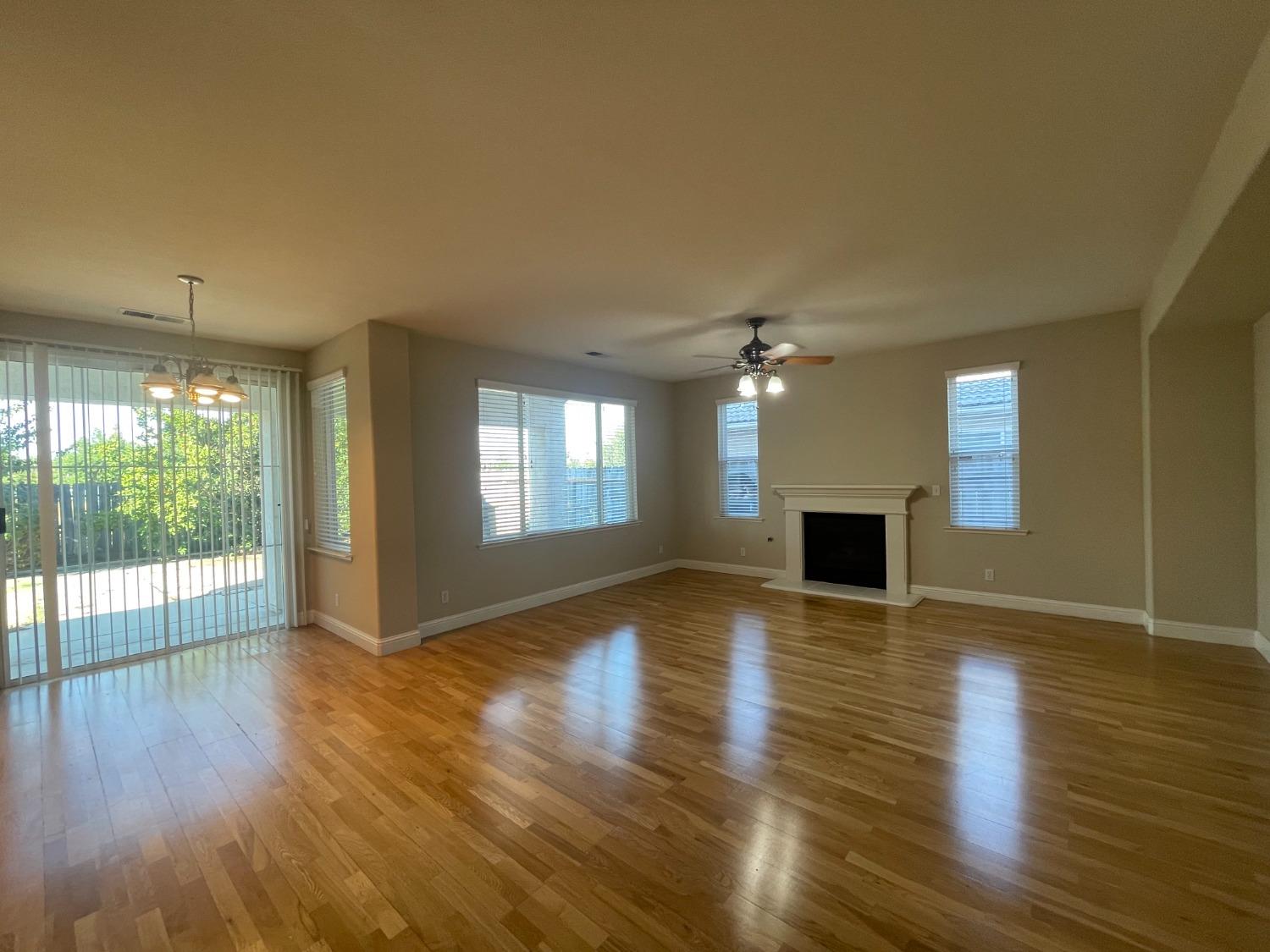 2616 Goshen Avenue Clovis, CA 93611 - Photo 5 of 39 a view of empty room with wooden floor and fireplace