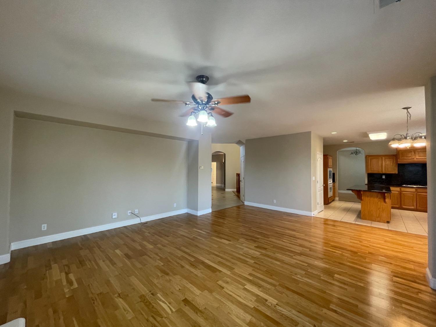 2616 Goshen Avenue Clovis, CA 93611 - Photo 6 of 39 a view of a livingroom with a ceiling fan and kitchen view