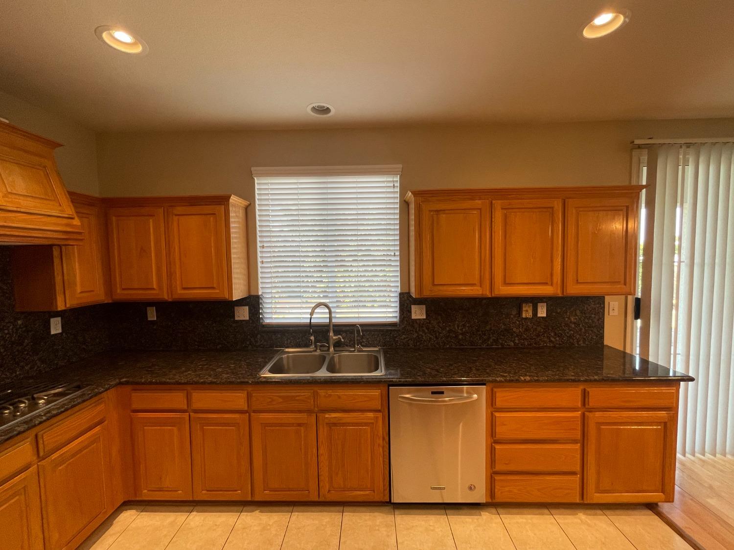 2616 Goshen Avenue Clovis, CA 93611 - Photo 8 of 39 a kitchen with granite countertop a sink and a granite counter tops