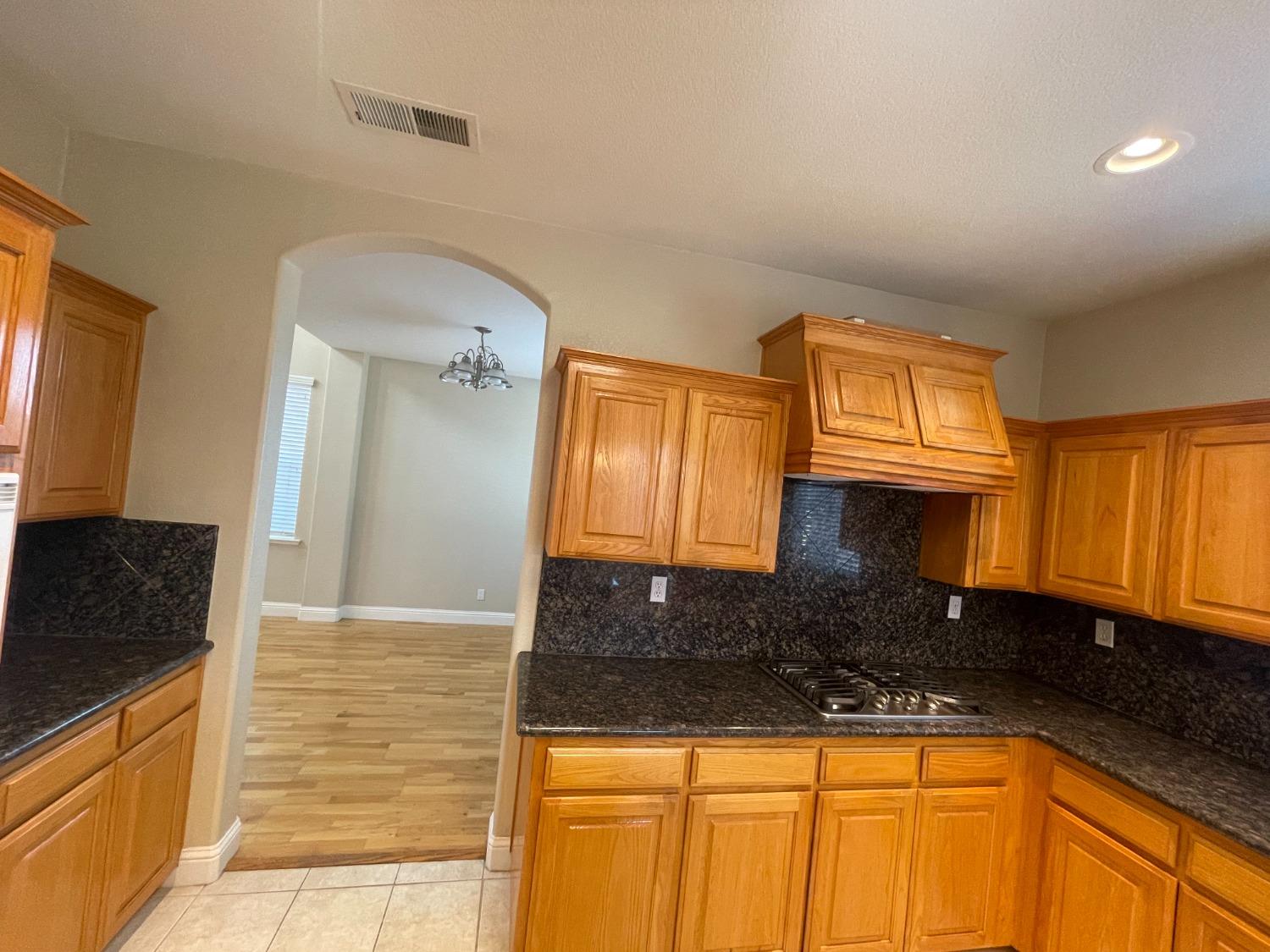 2616 Goshen Avenue Clovis, CA 93611 - Photo 9 of 39 a bathroom with a granite countertop sink and a mirror