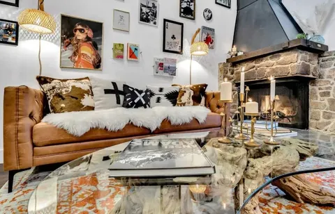 a living room with furniture and painting on the wall