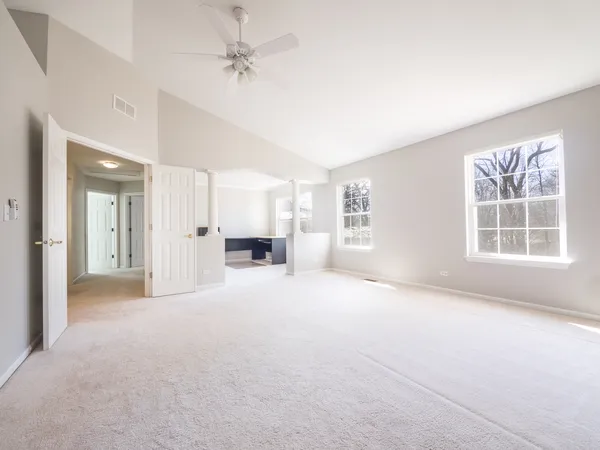 an empty room with windows and closet