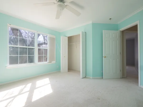 a spacious bathroom with a granite countertop sink a mirror and a bathtub