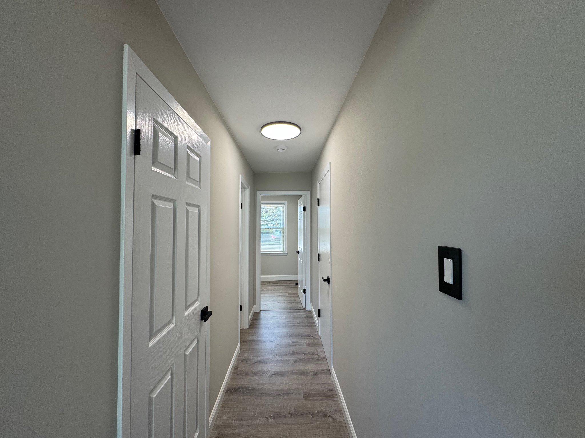8 Framingham Road Beverly, NJ 08010 - Photo 11 of 35 a view of a hallway with wooden floor and closet