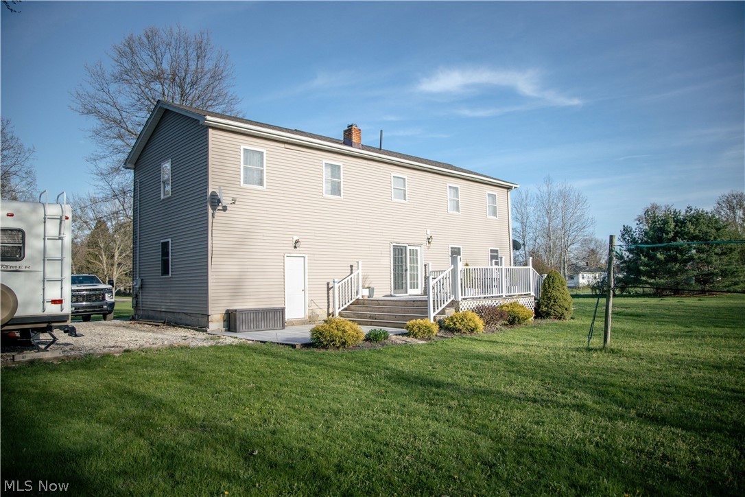 4750 Turney Road Madison, OH 44057 - Photo 40 of 42 Rear view of house featuring a yard and a deck
