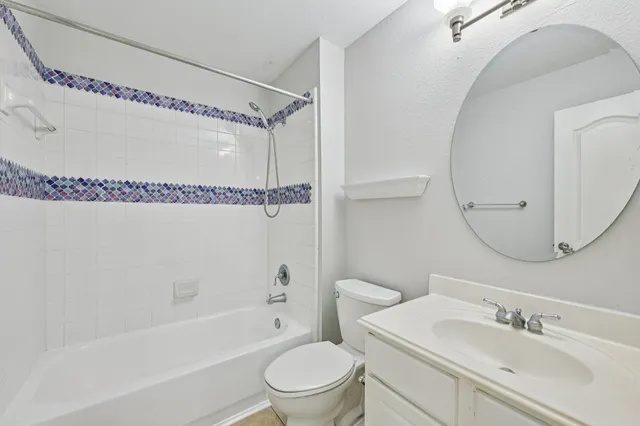 a kitchen with stainless steel appliances granite countertop a refrigerator a stove and a sink with wooden floor