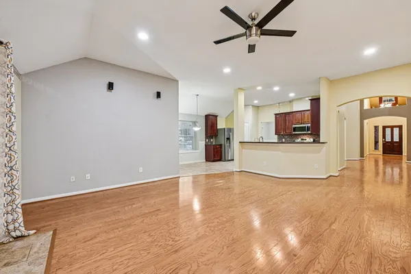 a view of a kitchen with a sink and a refrigerator