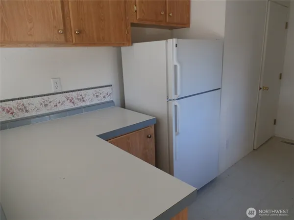 a white refrigerator freezer sitting in a kitchen