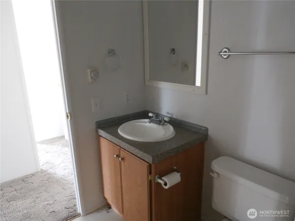 a bathroom with a granite countertop sink and a mirror