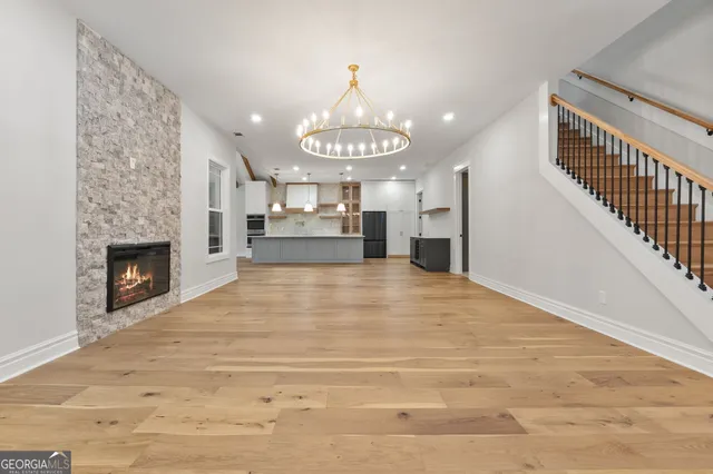 a kitchen with stainless steel appliances kitchen island granite countertop a refrigerator and a sink