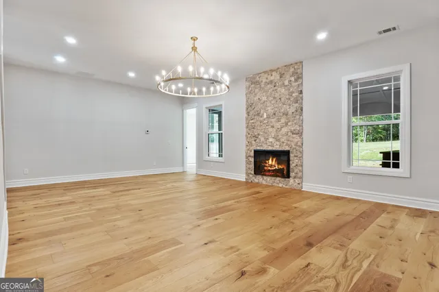 a large kitchen with stainless steel appliances a large counter top a oven and a sink