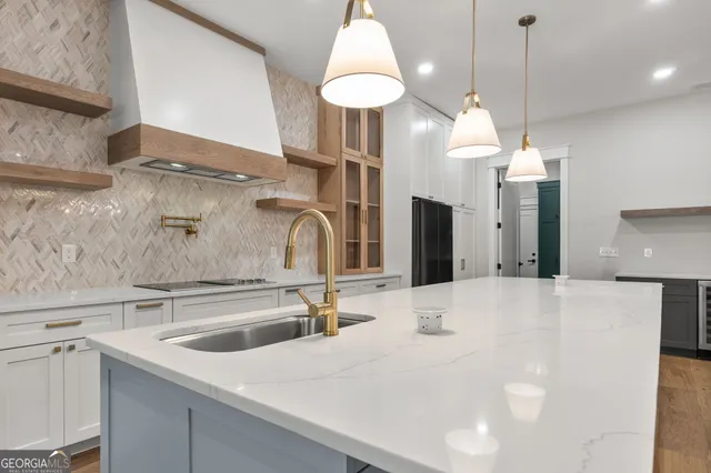 a kitchen with stainless steel appliances granite countertop a refrigerator and a sink