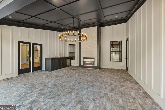 a bathroom with a tub a sink and a large mirror