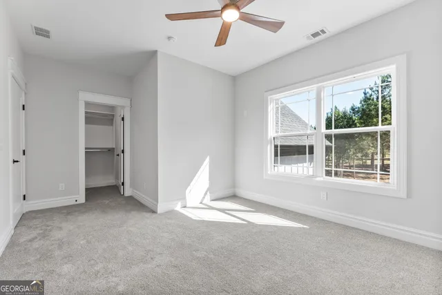 a house with green field in front of it