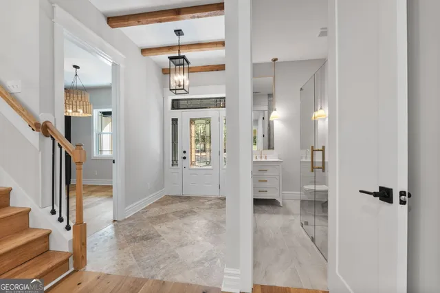 a view of entryway with a window and a ceiling fan