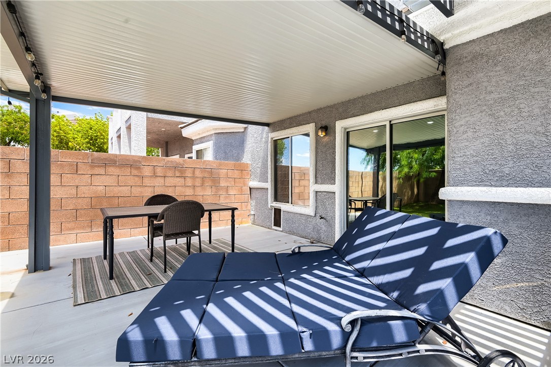 251 Integrity Ridge Drive Henderson, NV 89052 - Photo 27 of 28 An inviting covered patio area provides a private outdoor retreat with ample space for relaxation and entertaining.