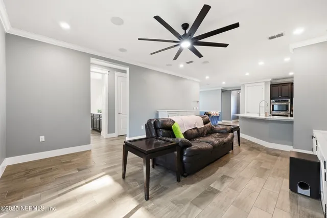 a bedroom with furniture and a ceiling fan