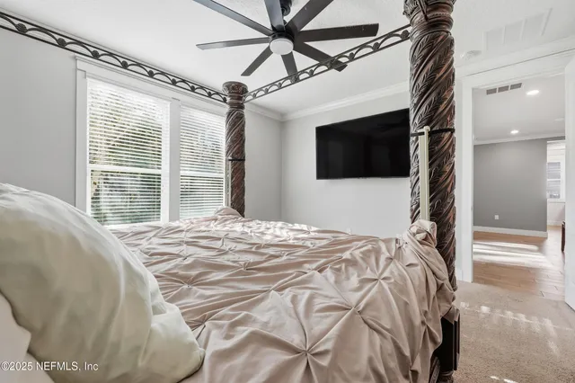 a bedroom with a bed and a chandelier