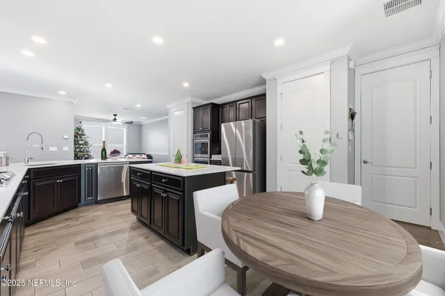 a kitchen with stainless steel appliances a refrigerator and a stove top oven