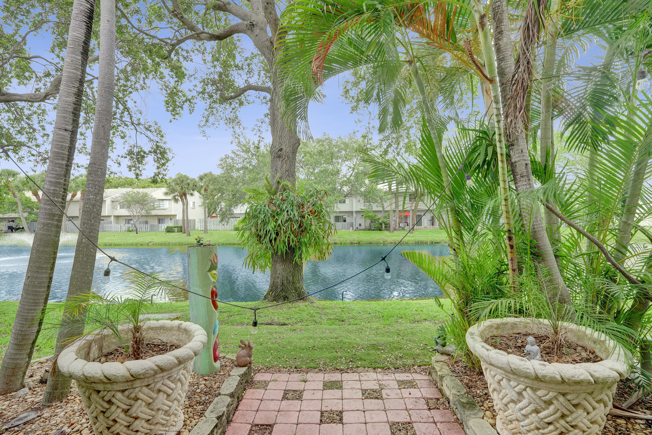 147 Southwest 3rd Street Pompano Beach, FL 33060 - Photo 14 of 29 a view of a backyard with plants and a fountain