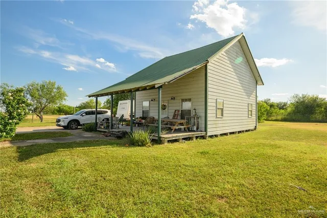 a view of a house with swimming pool and sitting area