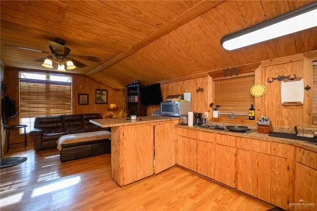 a kitchen with lots of counter top space and wooden floor