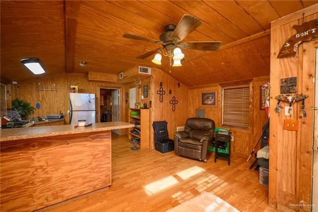 a view of a livingroom with furniture and gym equipment