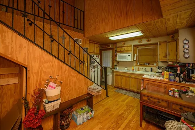 a kitchen with stainless steel appliances kitchen island granite countertop a refrigerator and cabinets