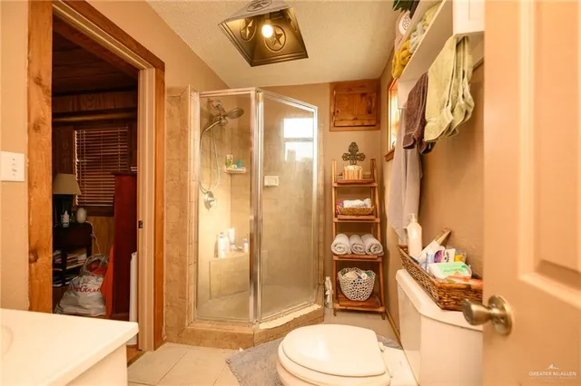 a bathroom with a toilet a sink and shower