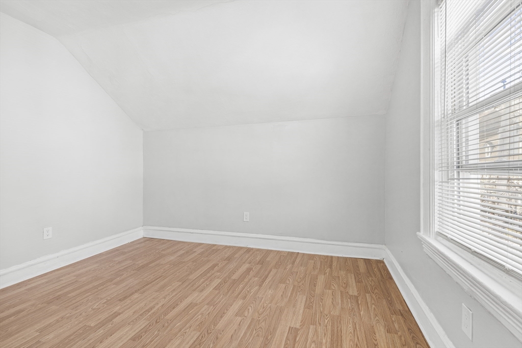 502 4th Street Fall River, MA 02721 - Photo 11 of 34 wooden floor in an empty room with a window