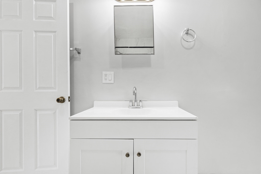 502 4th Street Fall River, MA 02721 - Photo 18 of 34 a bathroom with a sink and a mirror