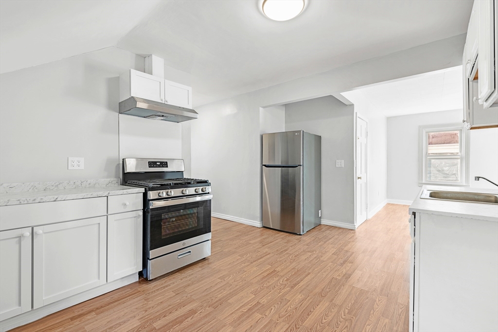 502 4th Street Fall River, MA 02721 - Photo 20 of 34 a kitchen with stainless steel appliances a stove a refrigerator and a sink