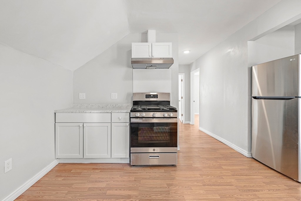 502 4th Street Fall River, MA 02721 - Photo 23 of 34 a kitchen with granite countertop a refrigerator and a stove