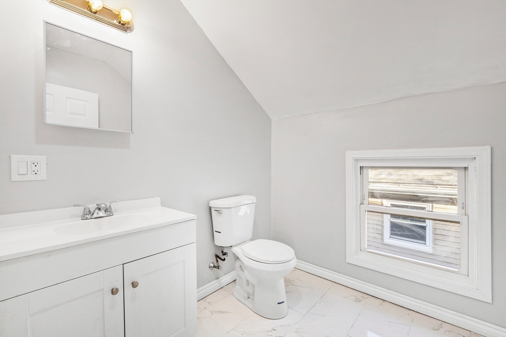 502 4th Street Fall River, MA 02721 - Photo 24 of 34 a bathroom with a sink a toilet and a mirror