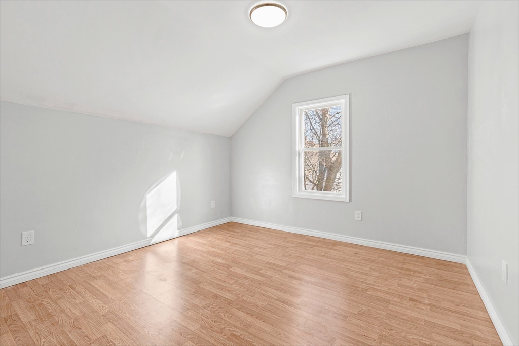 502 4th Street Fall River, MA 02721 - Photo 26 of 34 a view of an empty room with wooden floor and a window