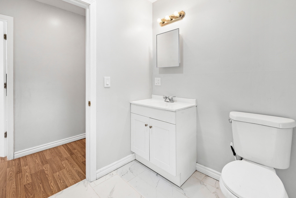 502 4th Street Fall River, MA 02721 - Photo 27 of 34 a white toilet sitting next to a bathroom sink