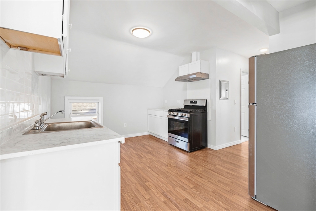 502 4th Street Fall River, MA 02721 - Photo 28 of 34 a kitchen with stainless steel appliances granite countertop a sink stove and refrigerator