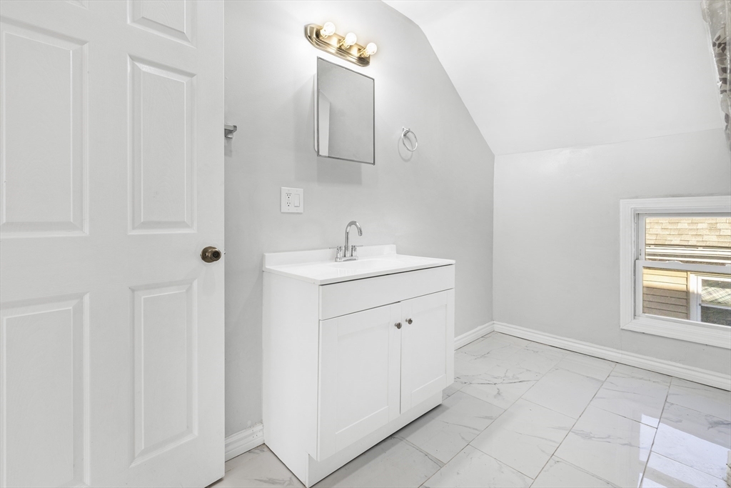 502 4th Street Fall River, MA 02721 - Photo 8 of 34 a bathroom with a sink and a mirror