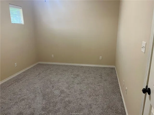 an empty room with a wooden door