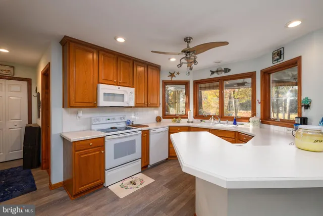 a kitchen with a sink appliances and cabinets