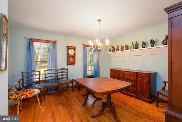 a view of a dining room with furniture and chandelier