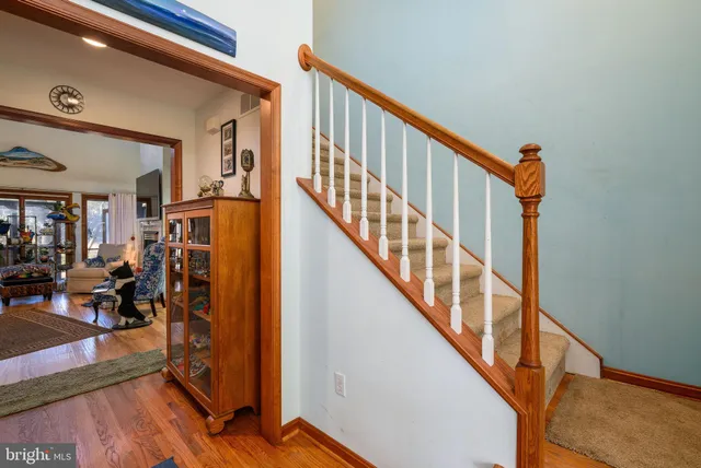 a view of staircase with a lots of frames on the wall