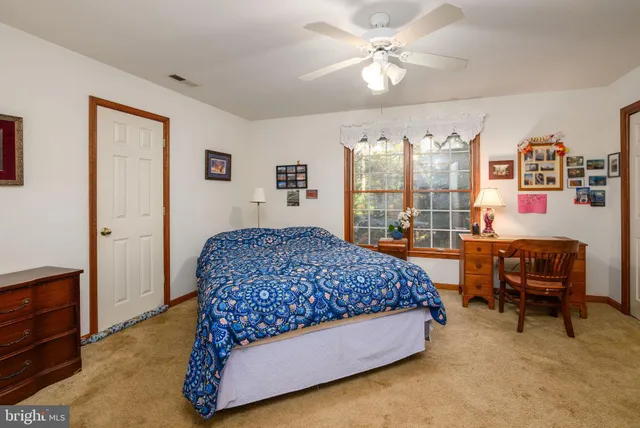 a living room with furniture a flat screen tv and a chandelier