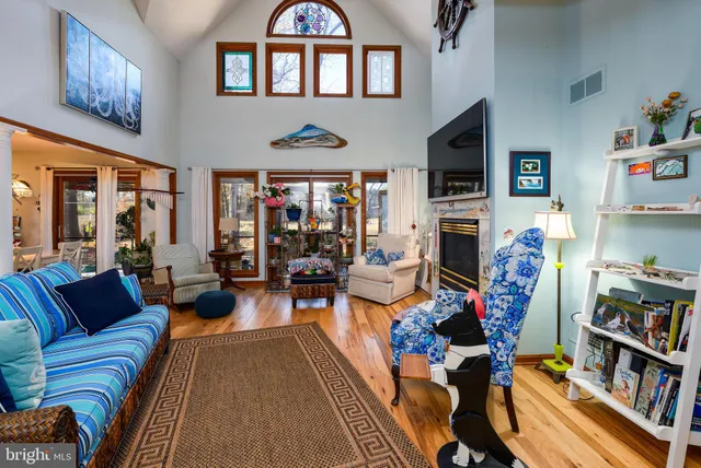 a living room with fireplace furniture and a flat screen tv