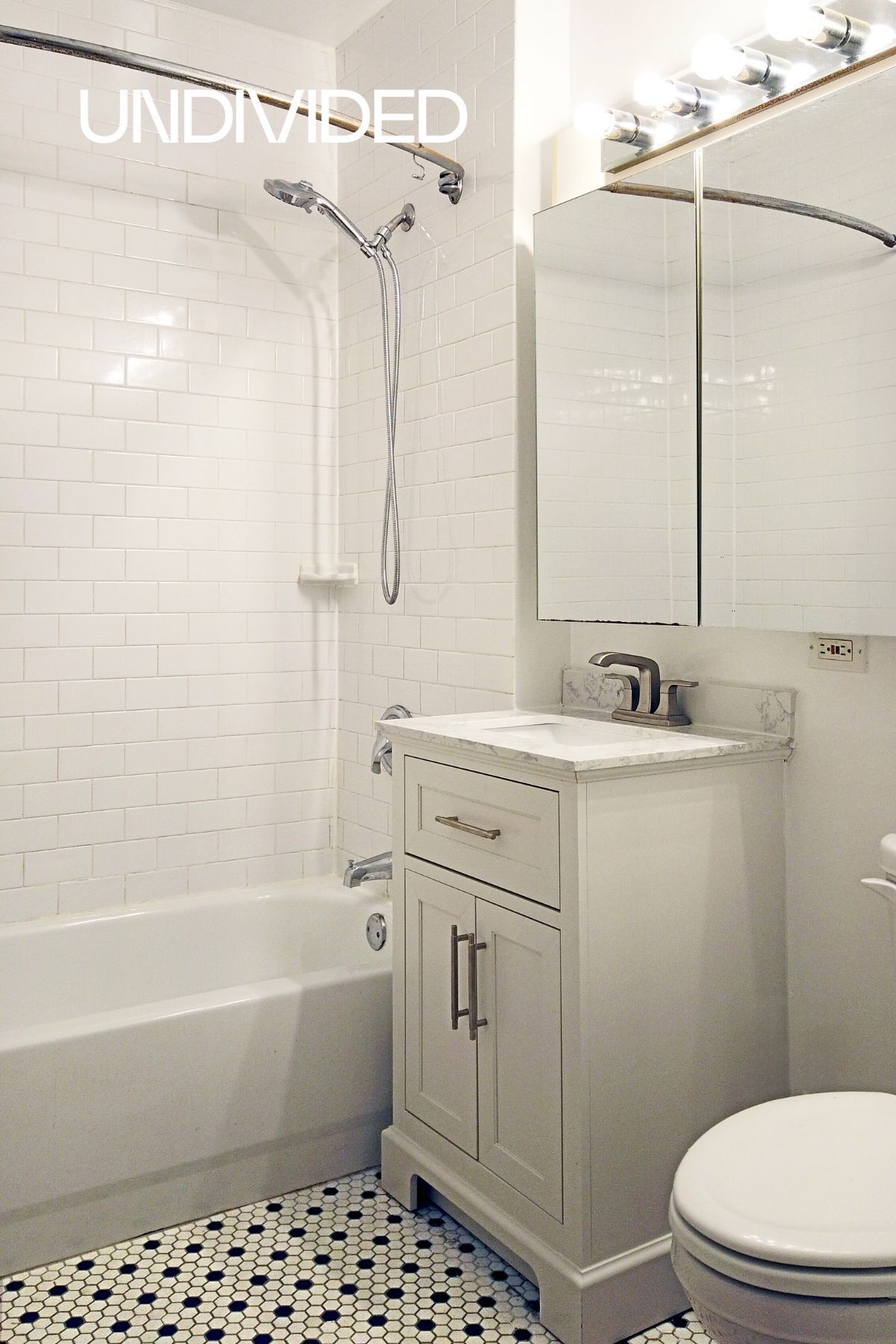 Undisclosed Address Manhattan, NY 10006 - Photo 5 of 9 a bathroom with a sink a toilet a mirror and shower