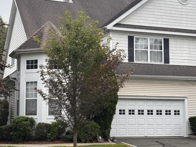 a front view of a house with plants